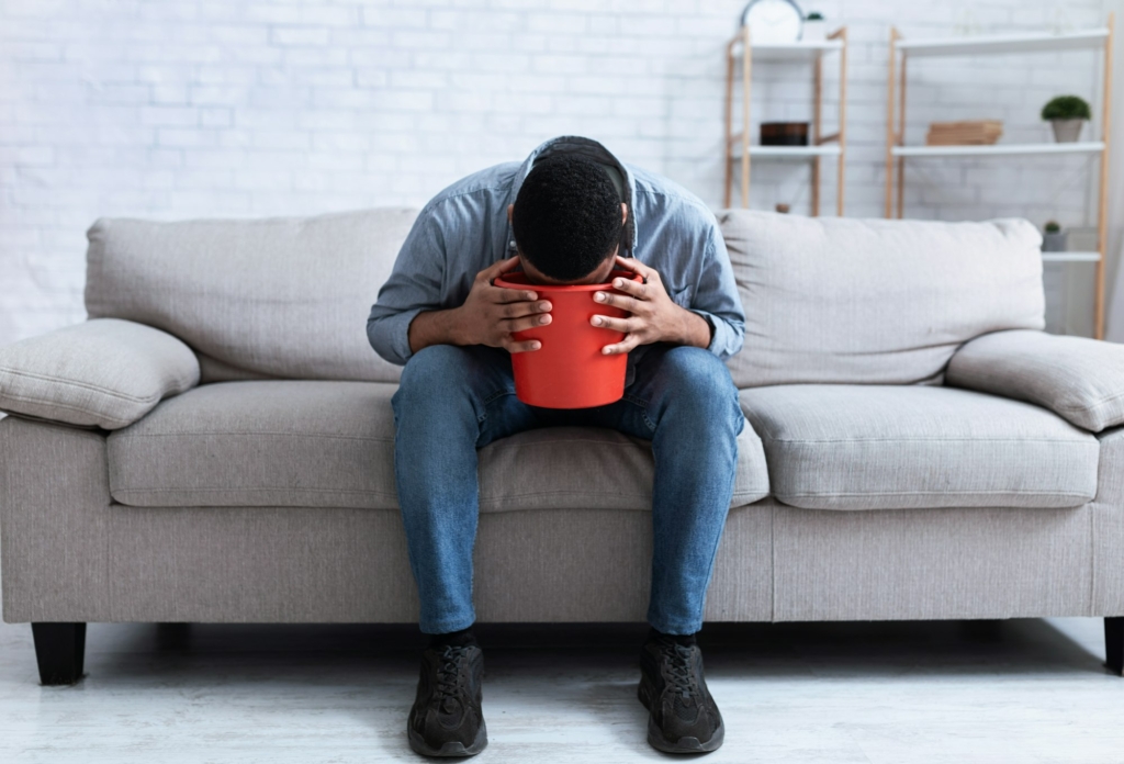 African Man Vomiting Into Bucket Because Of A Sliding Hiatal Hernia
