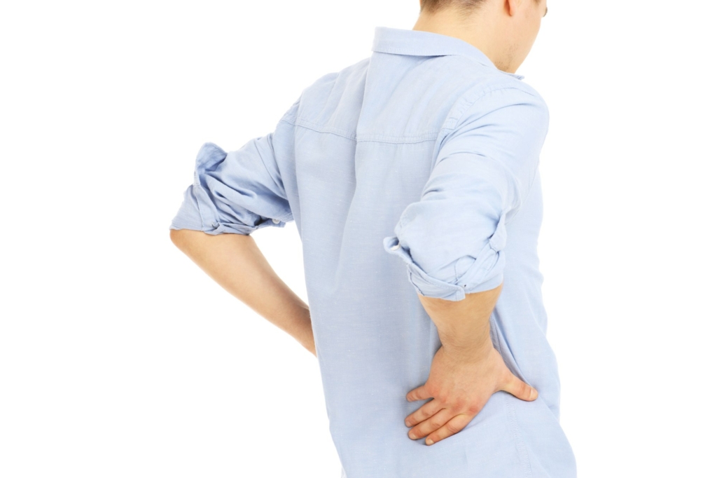 Young man suffering from back pain caused by a hiatal hernia.